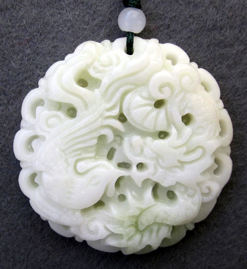 Zhou Dynasty White Jade Dragon Phoenix Pair Amulet: Approx Size: 2" Diameter. It is the customary and traditional belief of Chinese people that wearing the jade is the good means of which people will be protected from bad luck, evil spirit and danger. 
