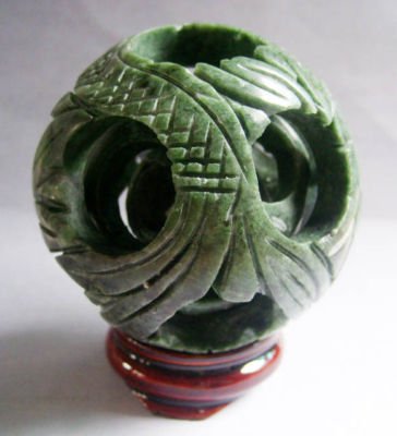 Green Jade Carved Three Layer Puzzle Ball: The Royal Cameo Carving Jade Charm was carved from a piece of fine grained Jade gemstone more than 200 years ago. The design is unique and very lovely and the carving is delicately performed. Size: 42