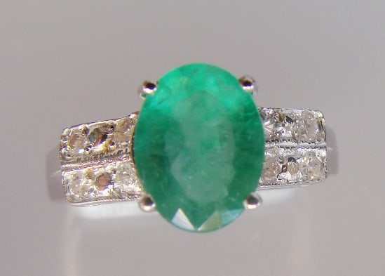 Emerald and Diamond Ring - Appraised at $11,725: Emerald Colombia, Weight: 1.65 carat, Clarity: SI 2, Color: Green. Diamond: 8 Pieces, Weight: .24 carat, Clarity: SI2, Color: H, 14k w/g 2.30 grams. Size: 6.5