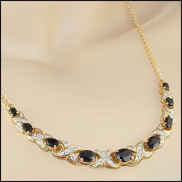 5.29 CT Sapphire & Diamond 18KGP Designer Necklace: 9 pieces of GENUINE Black Sapphires quality AAA no treatment.8 pieces of GENUINE 1.1mm faceted round diamond 0.06 carat Tw I-J color.10.48 grams of base metal layered with 18K yellow gold.The necklace