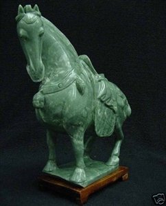 REAL JADE SADDLED TANG HORSE: This horse is made from one piece solid Taiwan jade. It appears light green with some area dark green. It comes with a wooden base. L: 8", W: 3", H: 8"