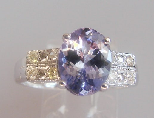 Tanzanite and Diamond Ring - Appraised at $12,470: Tanzanite: Weight: 1.73 carat, Clarity: AA+, Color: Violet Blue. Diamond: 8 Pieces, Weight: .24 carat, Clarity: SI2, Color: H, 14k w/g 2.30 grams. Size: 6.5