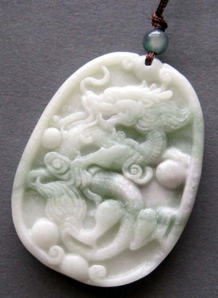 Zhou Dynasty White Jade Dragon Spit Pearl Amulet: Approx Size: 2" Diameter. It is the customary and traditional belief of Chinese people that wearing the jade is the good means of which people will be protected from bad luck, evil spirit and danger. 