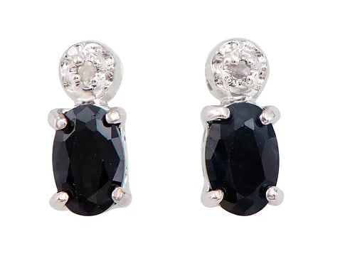 1.32 Cts Natural Black Sapphire Diamonds Rhodium Plated Designer Earrings: Gemstone DescriptionGemstone: Black SapphireColor: BlackShape: OvalSize: 6x4Quantity: 2CTW: 1.3 Diamond DescriptionShape: RoundsSize: 1.1mm Quantity: 2CTW: 0.02Grade: I3Color: H-I Material Information