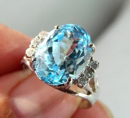 Blue Topaz & Diamond Ring - Appraised at $8,070: 40 carat round brilliant, Clarity SI-2-SI-3, Color G (Near-colorless), 7.70 carat genuine oval shape, Clarity Transparent, Color Swiss blue, 14k in White gold, 4.25grams, Size 6