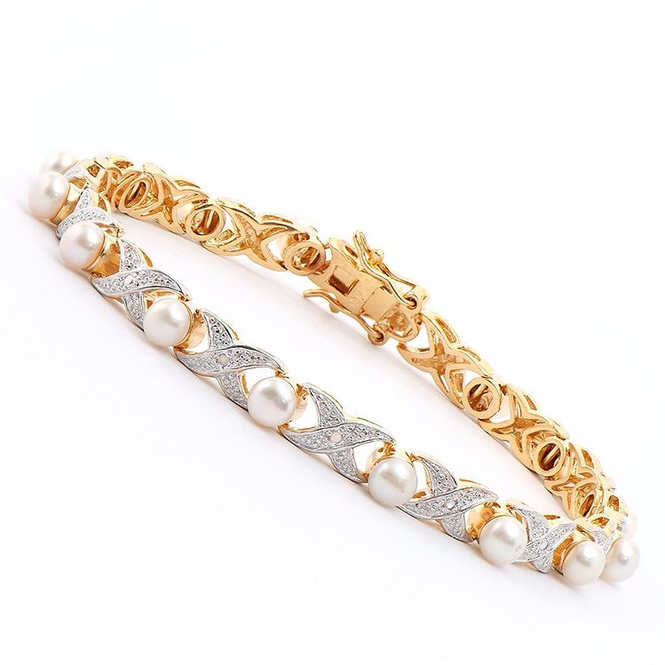 6mm Freshwater Pearl and Diamond Gold Bracelet: Master jewelers designed your bracelet with 17 pieces of 6mm freshwater pearls. 17 pieces of single cut diamonds, 0.1 carat tw. 11.4 grams of Base Metal layered with 18K Gold. The length is 7 1/2 inch