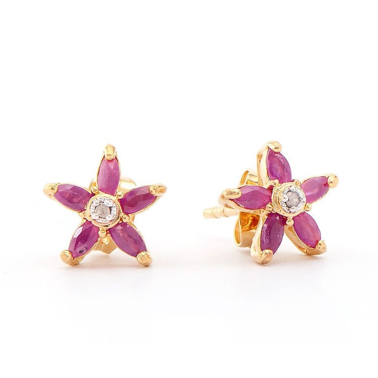 1.07 CT Ruby & Diamond Designer Earrings $900: 10 pieces of GENUINE 4x2 mm Red Rubies quality AAA no treatment.2 pieces of GENUINE single cut round diamonds 0.02 carat Tw.1.55 grams of brass layered with 18K yellow gold.The motif width is 5/8 inch