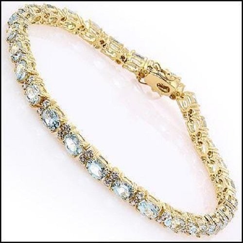 9.22 Ct Blue Topaz & Diamond 18KGP Designer Bracelet: 27 pieces of GENUINE 5 X 4 mm oval Blue Topaz . 6 pieces of GENUINE 1.1 mm faceted round diamonds, Color: I-J & Clarity: I2-I3 No treatment. 12.22 grams of brass layered with 18K yellow gold. The brac