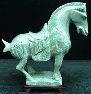 REAL JADE SADDLED TANG HORSE: This horse is made from one piece solid Taiwan jade. It appears light green with some area dark green. It comes with a wooden base. Size: L: 10", W: 3", H: 9"