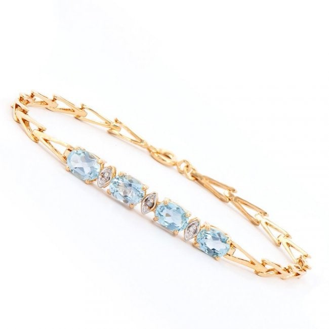 3.60 ctw Blue Topaz & Diamond Designer Bracelet $945: One Plated 18KT Yellow Gold 3.60ctw Blue Topaz and Diamond Bracelet. 4 pieces of 7x5 mm oval Blue Topaz stones. 3 pieces 1.2mm round diamonds with a clarity of I3. 5.05 grams of brass layered with 18K