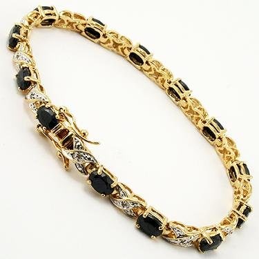 12.09 CT Sapphire & Diamond Designer Bracelet $1,350: 12 pieces of GENUINE 7X5mm oval black sapphires.12 pieces of GENUINE single cut diamonds, 0.09 carat tw.12.25 grams of brass layered with 18K yellow gold.The length is around 7 1/2 inches.The width is