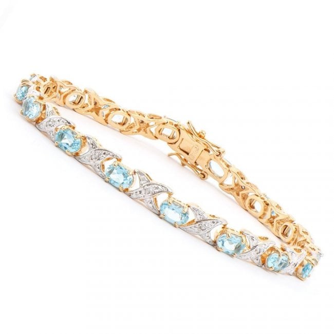 9.05 ctw Blue Topaz & Diamond Designer Bracelet $1,330: One Plated 18KT Yellow Gold 9.00ctw Blue Topaz and Diamond Bracelet. (16) Blue Topaz stones with a total weight of 9.0cts. (16) Diamonds with a total weight of 0.12cts with a color of I-J and clarity 