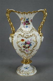 Davenport Hand Painted Rococo Scrollwork Vase: Rare bone china vase with relief molded Rococo scrollwork and shell designs with gilt highlights. The handles are gilt with relief molded figural heads at the bottom. Decorated with hand painted fruit
