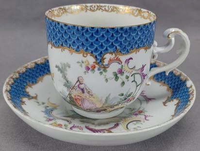 18th Century Meissen Watteau Scene Cup & Saucer: Nice antique porcelain cup and saucer. Decorated with hand painted Watteau scenes of a lady on one side of the cup and a man on the other framed in purple, yellow, green and blue scrollwork and small