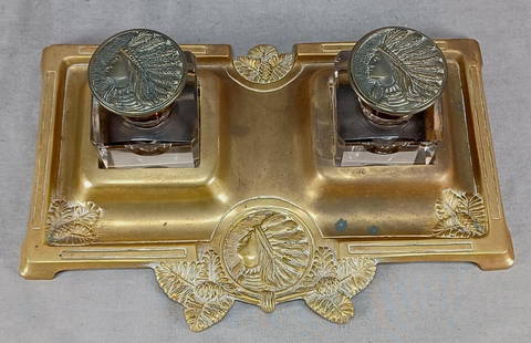 Antique Native American Heads Inkwell Inkstand: Nice antique late 19th century brass inkwell inkstand with repousse Native American Indian head and pine cones. Has clear cut and polished glass inkwells with matching brass lids. Unmarked.Has some we