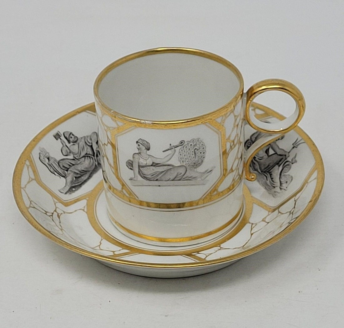Worcester Barr Flight & Barr Coffee Cup & Saucer: Worcester Barr, Flight & Barr Coffee can and saucer. Greek / Roman scenes with gold gilt. Approximate measurements: saucer is 5 inches in diameter and 1 inch tall. The cup is 2 3/8 inches tall and 2 1