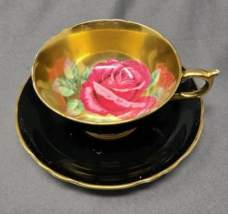 Paragon Cabbage Rose Black Gold Teacup & Saucer: Paragon floating rose tea cup and saucer set. Black with gold and a red rose. No chips or cracks. There are marks on the black on both the cup and saucer. There is also a rub mark where the cup rests