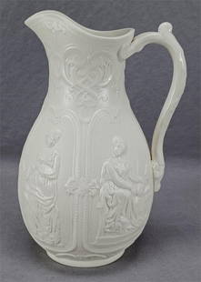 Brownfield International Pattern 8 1/4 Inch Jug: Antique British white relief molded International stoneware jug. Marked on the base International above a British registry diamond and WB in a Staffordshire knot. Registered by William Brownfield,