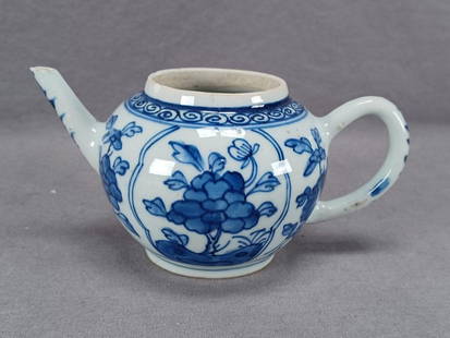 Chinese Kangxi Blue Floral Porcelain Teapot: Antique Chinese Export Kangxi period porcelain teapot. Hand painted underglaze blue floral and scrollwork pattern. Unmarked. Circa 1710.Has two chips to the rim, a chip to the spout, and it is missing