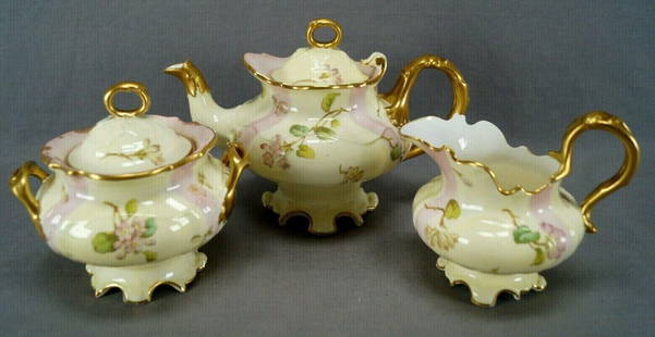Cauldon Pink & Yellow Floral & Gold Tea Trio: Nice antique British bone china teapot, creamer and sugar set in the Rivoli shape. Decorated with pink and yellow flowers over a yellow background with pink panels. Gold gilding along the edge and to