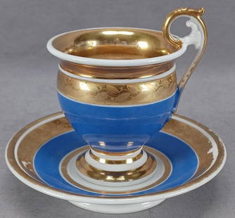 Old Paris Porcelain Gold Leaves Blue Cup & Saucer: Antique Old Paris / Vieux Paris empire form cup and saucer. Decorated with gold leaves over a gold band above blue. Gold gilding along the rim. Unmarked. Circa 1815.Has some wear to the gilding and
