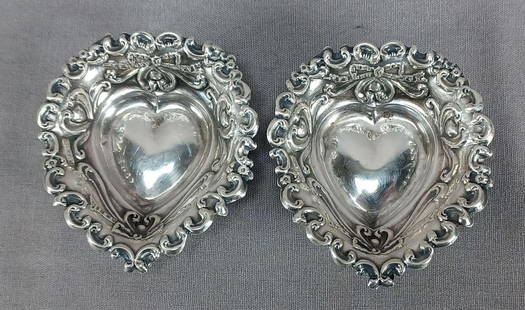 2 Robert Pringle Birmingham Sterling Silver Salts: Pair of late Victorian era sterling silver heart shaped salts. With repousse bows and scrollwork. Hallmarks for Robert Pringle & Sons, Birmingham, and date letter for 1899.These have some wear and