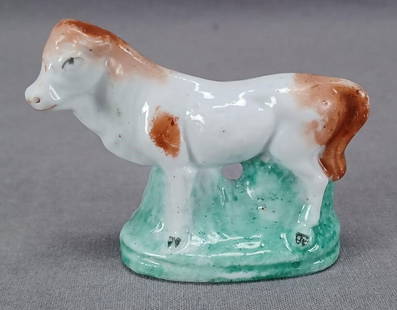 Hand Painted Porcelain Cow Figurine C 1830-1850s: Rare 19th century hand painted continental hard paste porcelain cow figurine. Unmarked. Probably made in France, Germany, or Bohemia between the 1830s and 1850s.Good condition.Measures approximately 2