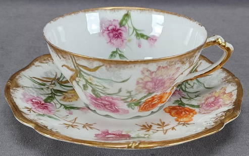 Limoges Pink Orange Flowers Gold Tea Cup & Saucer: Nice antique French porcelain tea cup and saucer. Decorated with large pink and orange carnation flowers with raised gold leaves. With clouded / sponged gold gilding along the edge and to the handle.