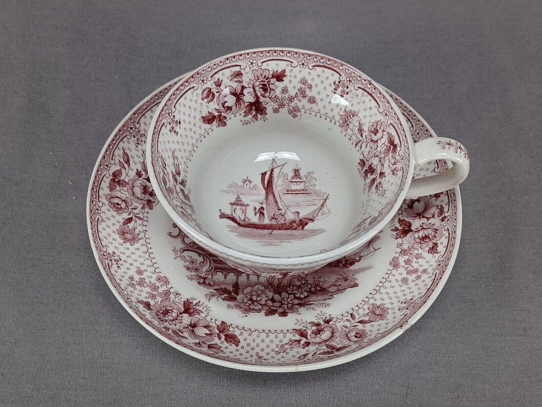 Ridgway Japonica Transferware Tea Cup & Saucer D: Nice antique earthenware tea cup and saucer. Decorated in the Japonica patter in mulberry transfer. Marked on the bottom Japonica JR. Produced by John Ridgway. Circa 1830 to 1855.Has some wear consist