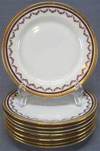 Set of 8 Lanternier Limoges 8 7/8 Inch Plates: Set of 8 porcelain plates decorating with a gold encrusted Greek key pattern along the edge. Has another band of black below that, with a sort of gold chain design. Followed by a band of dark pink ros