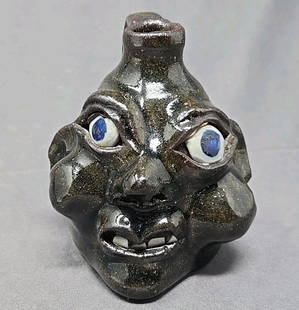 Grace Nell Hewell Mini Face Jug Folk Art Pottery: American folk art face jug by Grace Nell Hewell. She lived in Gillsville, Georgia, from a multi generational of Hewell's who have passed down the craft. She lived from 1933 to 2016. Made from red