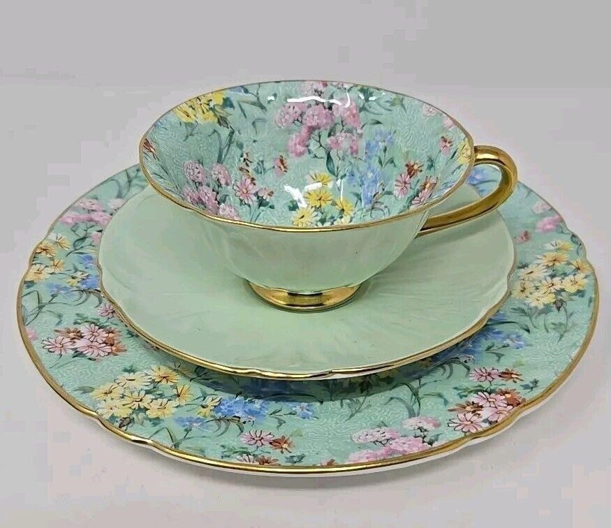 Shelley Tea Trio Melody Chintz Oliander Form: Shelly trio in mint green tea with tea cup, saucer, and small plate. Chintz design with flowers. The cup and saucer are the Oleander form. Measures approximately: the plate is 8 inch diameter. The sau