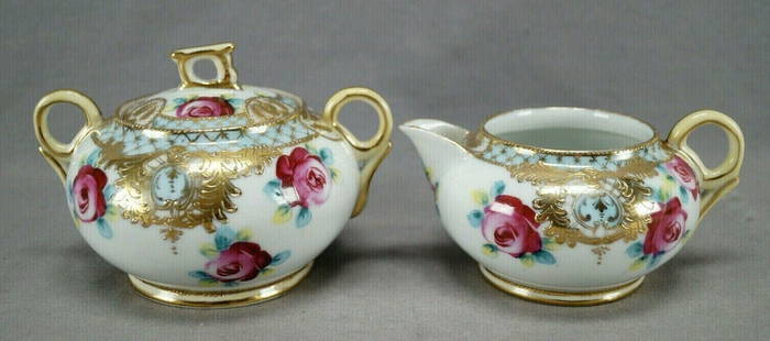 Nippon Hand Painted Roses & Gold Creamer & Sugar: Antique Japanese porcelain creamer and sugar with large hand painted dark pink roses. With pale blue bands along the lip and the edge of the sugar lid with gold gilt net overlay, and gold beading abov