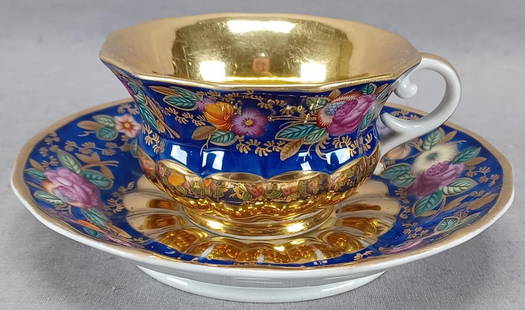 Russian Safronov Hand Painted Tea Cup & Saucer F: Nice antique 19th century Russian porcelain tea cup and saucer. Decorated with hand painted purple, orange, and yellow flowers with green and gold leaves over a cobalt background. Gold gilding along t