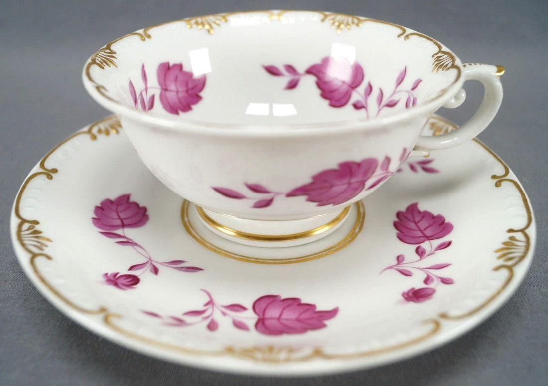 KPM Berlin Pink Leaves & Gold Tea Cup C1832-37: Nice porcelain tea cup and saucer. Nicely decorated with hand painted pink leaves and flowers. With fancy gold gilt scrollwork along the edge, gilt highlights to the handle of the cup, and gold gildin