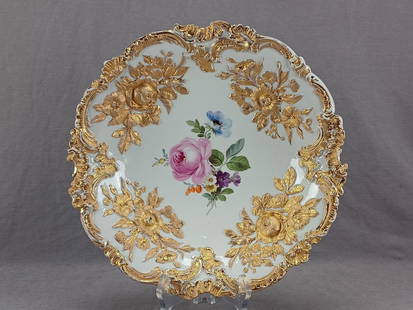 Meissen Hand Painted Pink Rose Bowl: Antique German porcelain porcelain. Hand painted central bouquet with a pink rose and flowers in blue, purple, white, yellow, and orange. Relief molded roses, flowers, and scrollwork with heavy gold