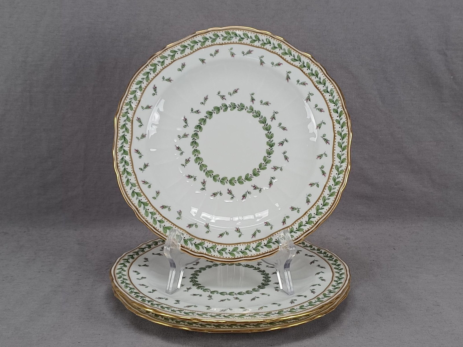 3 Minton Pink Floral & Gold 8 5/8 Inch Plates: Set of 3 British bone china plates. Decorated with pink floral buds, green leaf bands, gold bands, and gold beading. Marked on the reverse Mintons England in puce. One of the plates has an impressed d