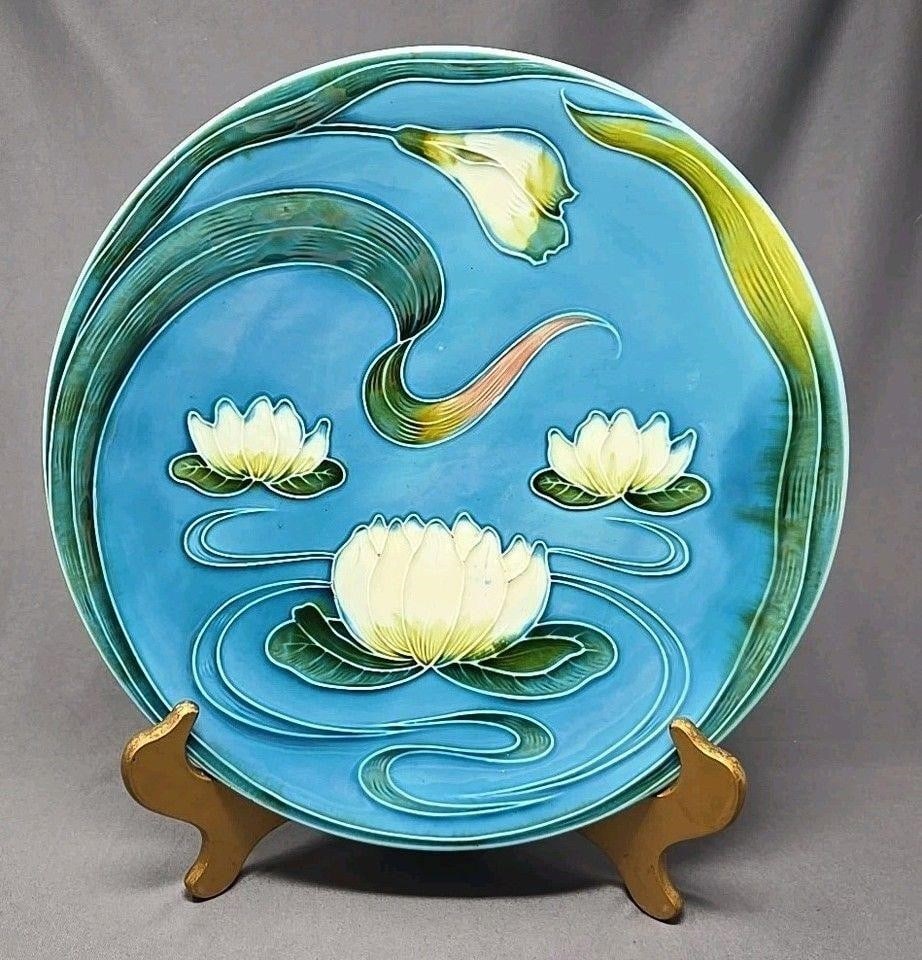 Zell Majolica Lotus Water Lilies 11 3/4 Plate: Art Nouveau Zell baden GS ( Georg Schmider), 11 3/4 inch plate. Pattern 2174, water lilies. Circa 1907 to 1928. There are a few spots with glaze chips. Light scratches from use. We can offer packaging