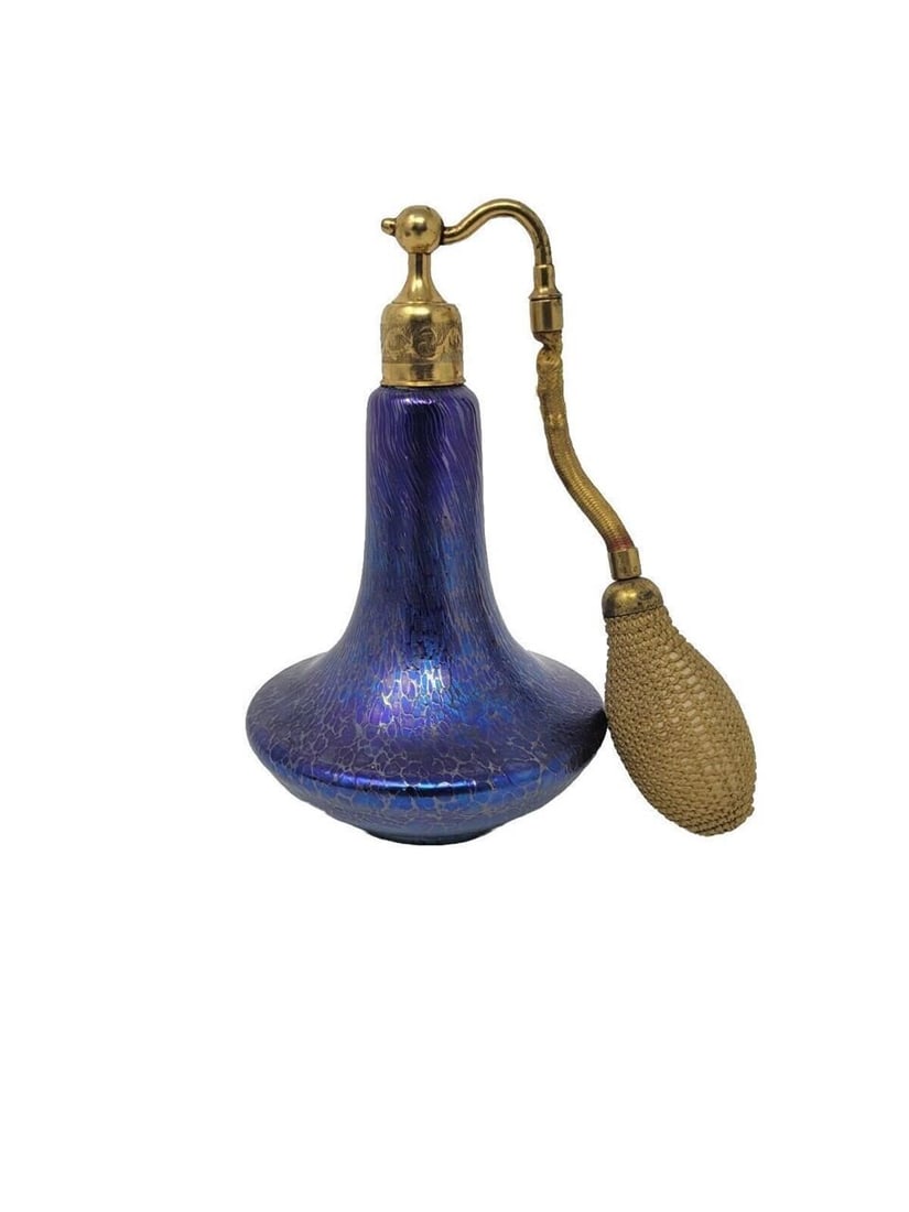 Loetz Blue Iridescent Oil Spot Atomizer Perfume: Hand blown blue Loetz atomizer perfume bottle with oil spot iridescent design. Circa 1900. Very good condition, the cloth on the atomizer is frayed. There are no chips or cracks. Spots turn into lined
