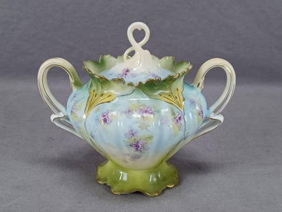 RS Prussia Mold 652 Floral Porcelain Sugar: Antique RS Prussia porcelain sugar in mold 652. Decorated with small purple flowers over a blue, yellow, and green background with gold highlights. Clouded / sponged gilding along the edge. Unmarked.