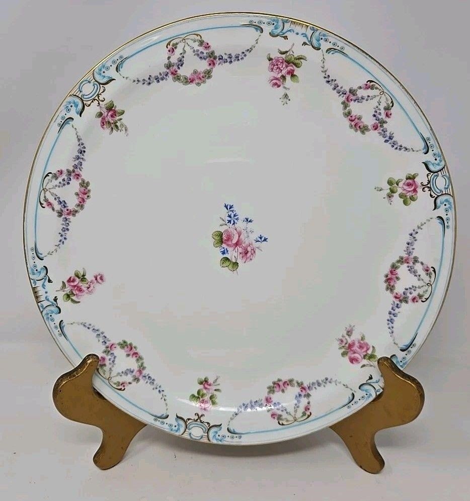 Mintons Porcelain Dinner Plate Floral Garland: Minton Dinner Plate with floral garlands and wreaths and a light blue border. Measures approximately 10 3/4 inches in diameter. Circa 1898, pattern G 7601. Retailed by Gilman Collamor of New York City