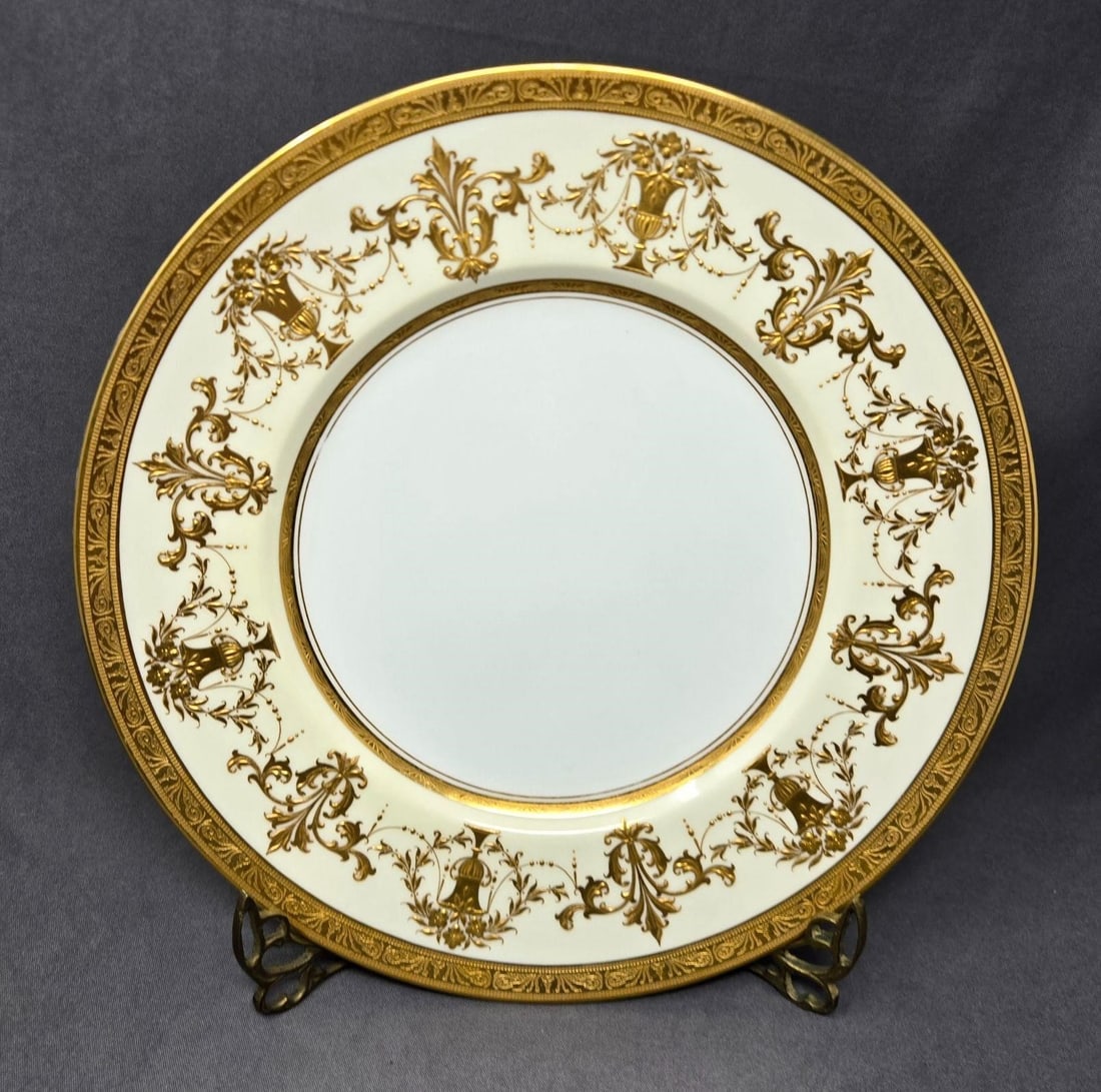 Minton Raised Gold on Cream Dinner Plate 10 1/4": Minton dinner plate circa 1916. Raised gold urns with flowers and Fleur-de-lis pattern on a creme border and white center. Measures approximately 10 1/4 inches in diameter. No chips or cracks, minor s