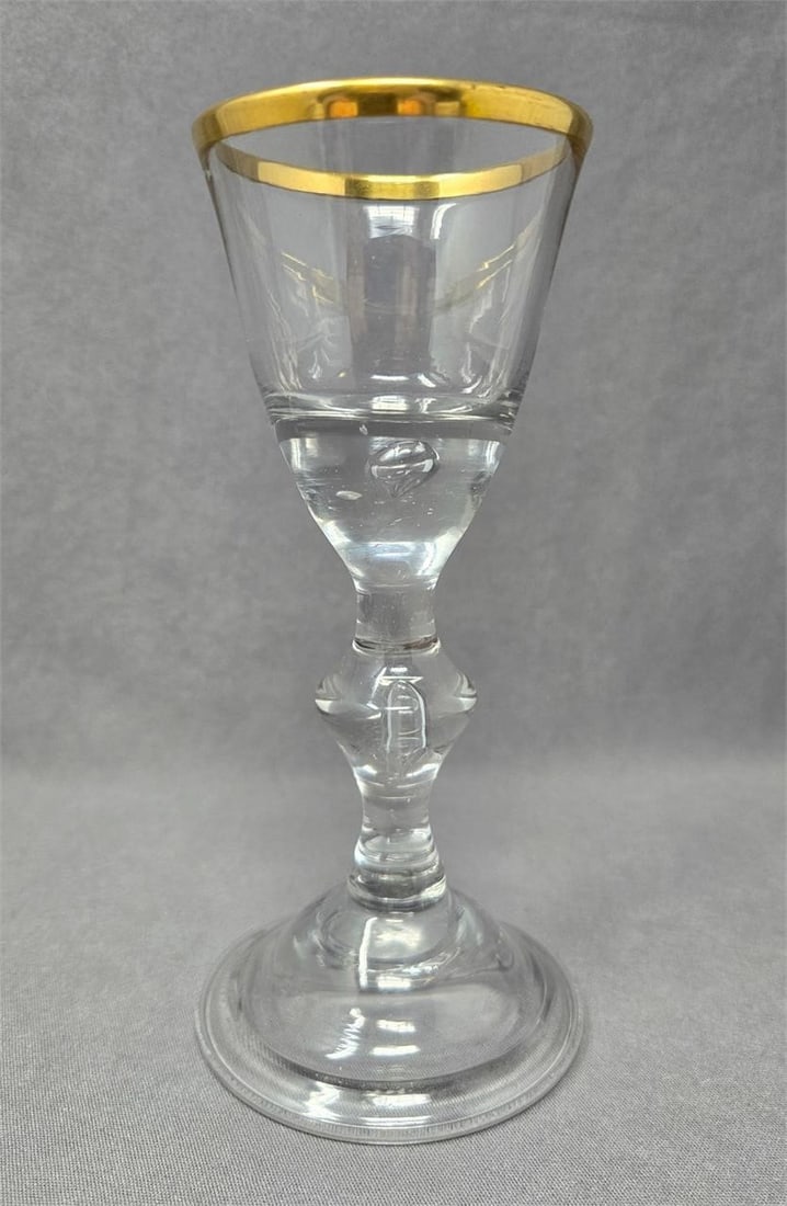 Lauenstein Controlled Bubble Wine Glass C. 1770: Lauenstein German wine glass with controlled bubbles at base of cup and stem Knop. Marked with lion on rough pontil. Measures approximately 6 1/4 inches tall and 2 1/2 inches in diameter. Very nice co
