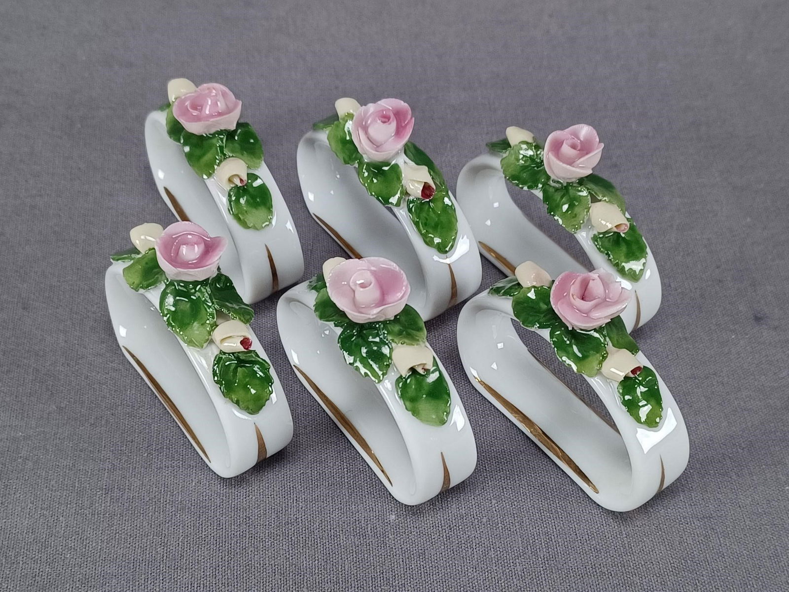 Set of 6 Alka Dresden Style Napkin Rings: Set of 6 porcelain napkin rings with pink and yellow encrusted roses. Gold highglights. Marked with a blue crown above AK. This mark was used by "Alka" (Alboth & Kaiser) between 1967 and 1970.One has