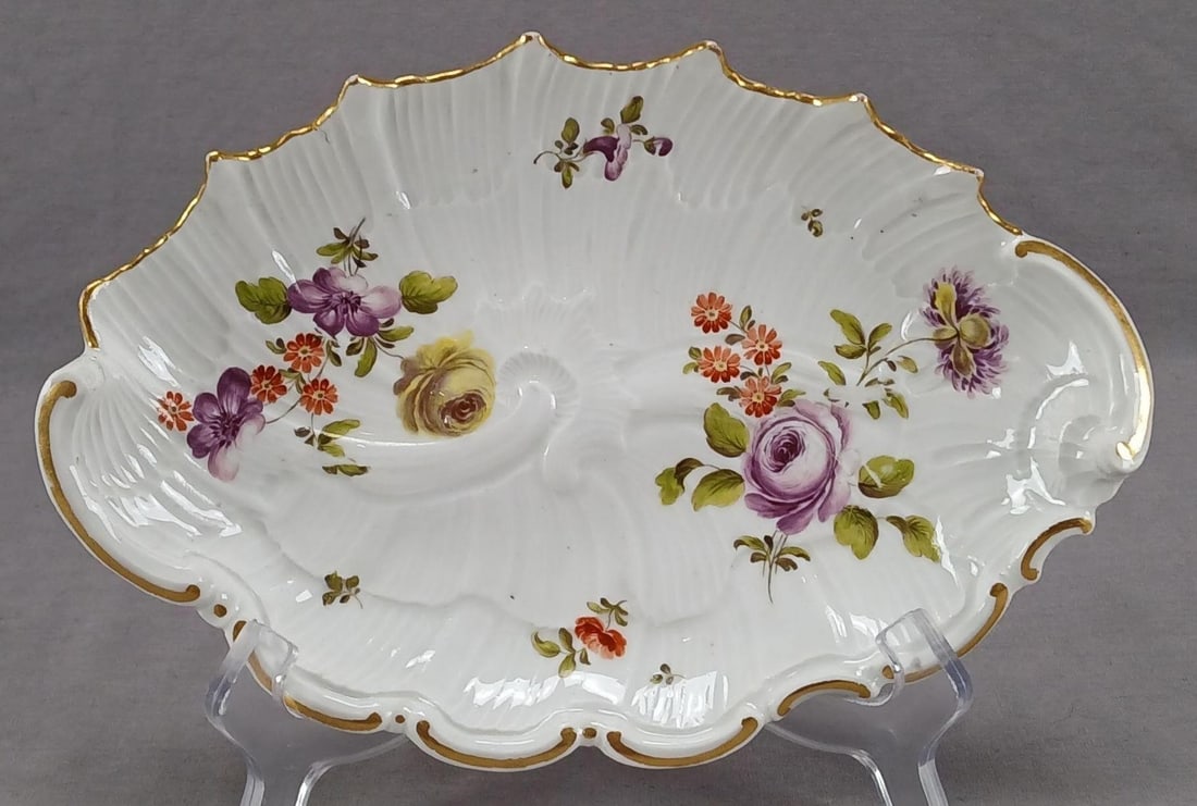 18th Century Royal Vienna Floral Rococo Shell Dish: Antique 18th century authentic Royal Vienna porcelain Rococo style shell dish. Decorated with hand painted purple and ywllow roses and purple, orange, and yellow flowers. Gold gilding along the edge.