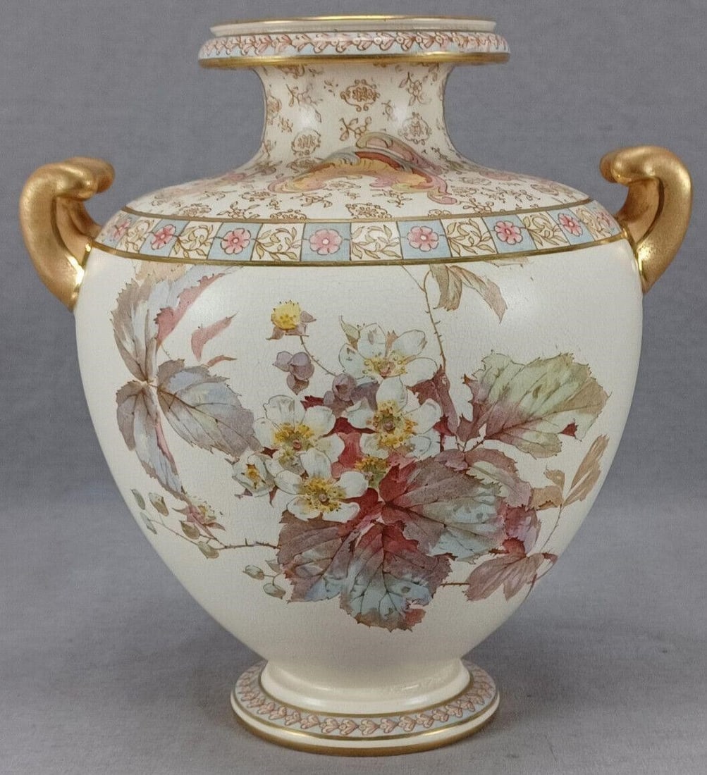 Doulton Burslem Earthenware Vase C. 1886-1891: Antique British earthenware pottery vase. Decorated with white blossoms with thorns over an ivory background. Has bands of pink flowers over blue squares and scrolled leaves over ivory squares. With m