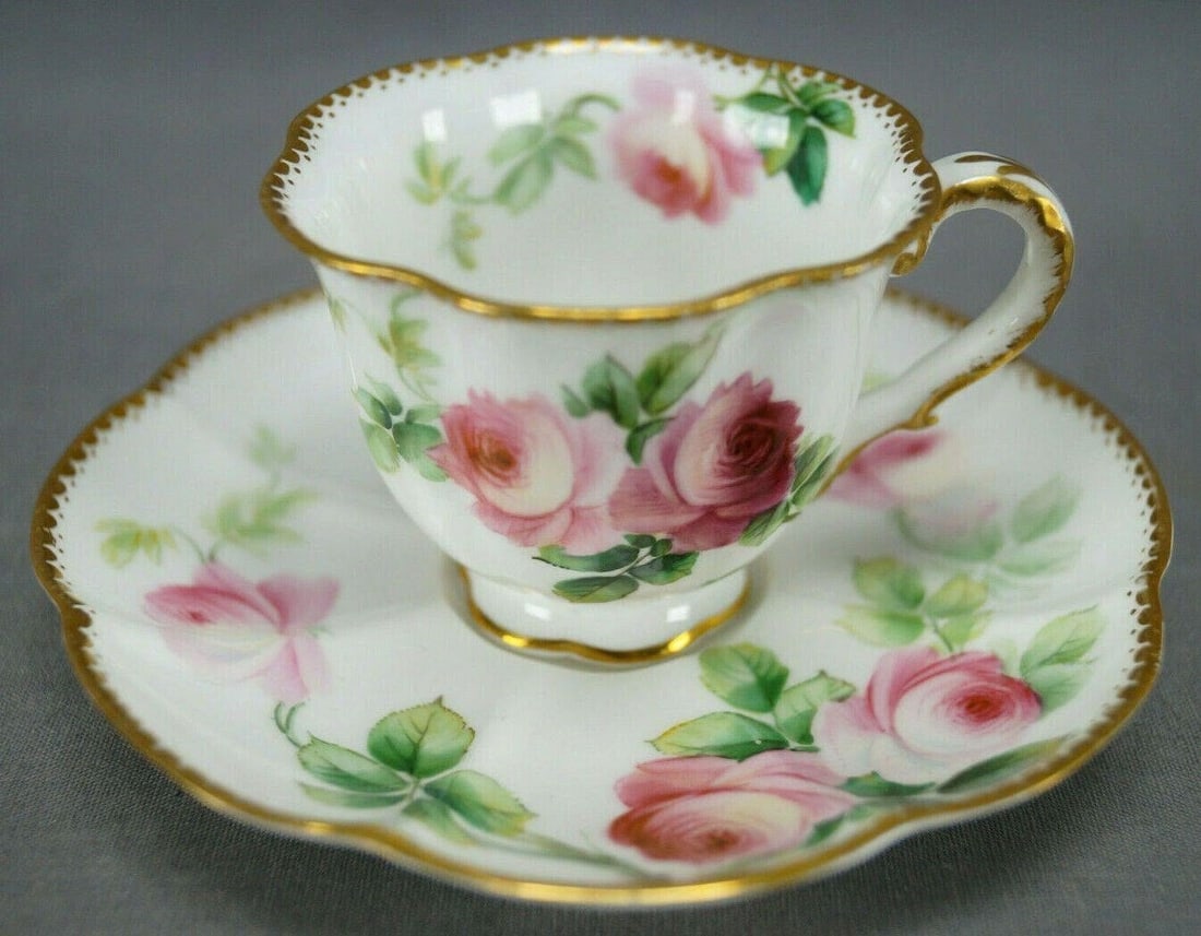 George Jones Pink Rose Demitasse Cup & Saucer: Pretty antique bone china demitasse cup and saucer. Decorated with large hand painted pink roses. With gold gilt scallops and small dots along the edge. Marked on the bottom Crescent GJ & Sons China E