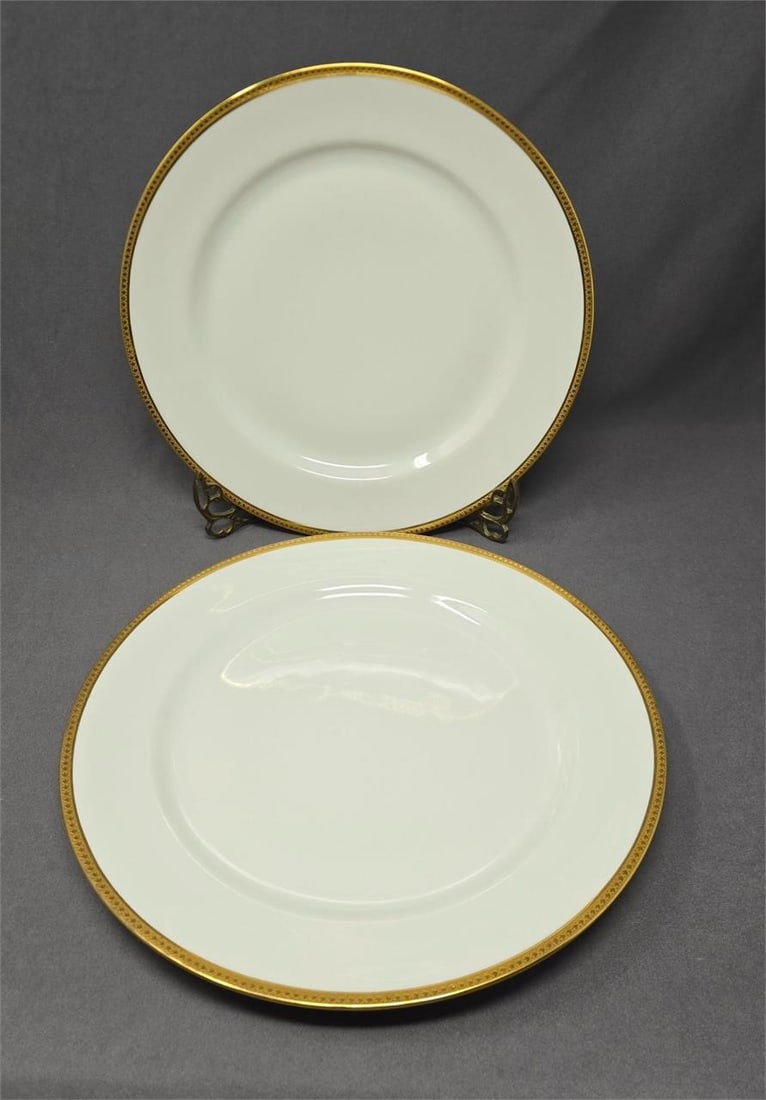 Set 2 Jean Pouyot Limoges Dinner Plates 9 5/8": Set two Jean Pouyot Limoges dinner plates. Retailed by John Wananmaker of Philadelphia PA. Gold band on edge. No chips or cracks ore crazing. One has two darker spots on the gold. They look unused wit