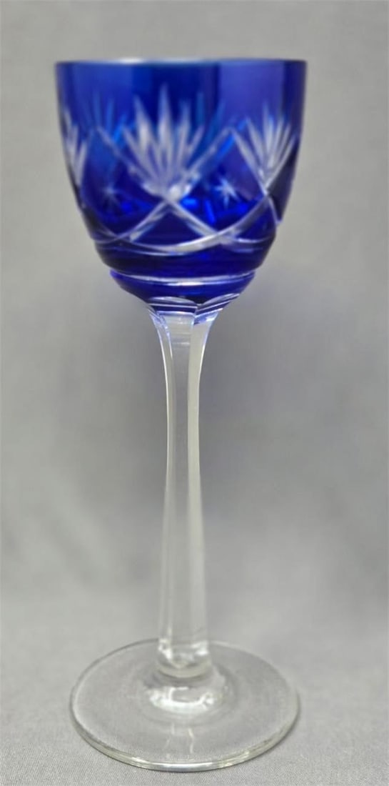 German Cobalt Blue Cut to Clear Wine Glass 8": Cobalt blue cut to clear with fans and stars on bowl and a faceted stem hock or Rhine wine glass. German early 1920s. Flea bite on stem otherwise very good condition. Measures approximately 8 inches t