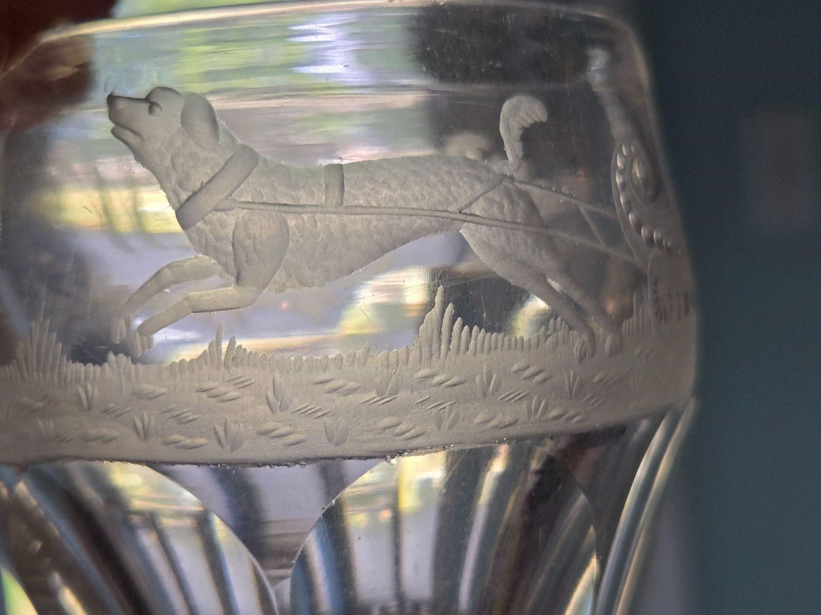 British Dog Pulling Sleigh Engraved Whiskey 1800s: Fine etching of a dog pulling a sleigh, thistle plants and monogrammed with A. W. small whiskey glass. Measures approximately 2 5/8 inches tall and 3 inches at widest with a 2 5/8 inches opening diame